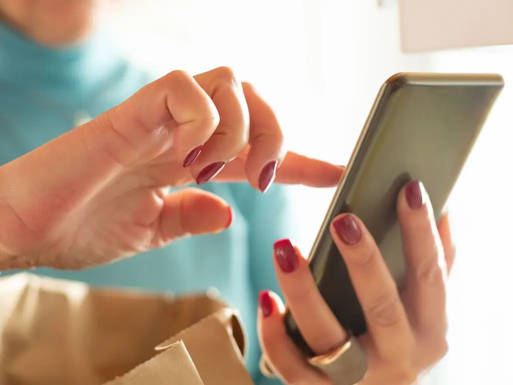 A hand holding a smartphone